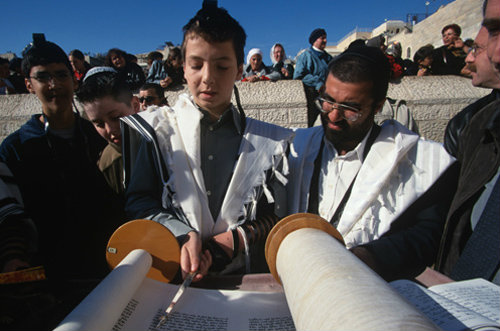 Israel Jerusalem Western Wall a Bar mitzvah, boy holding a Yad whilst reading from the Torah