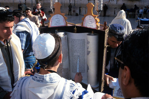 Israel Jerusalem Western Wall a Bar mitzvah, boy holding a Yad whilst reading from the Torah