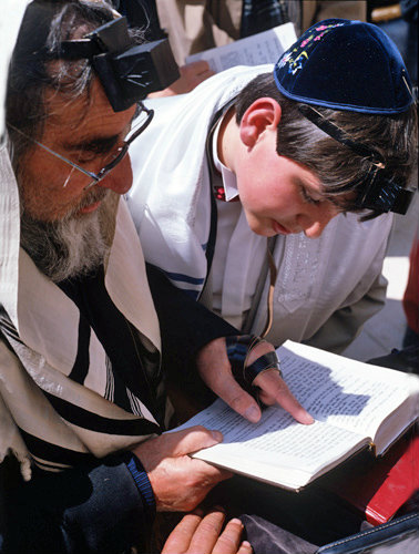 Israel Jerusalem Jewish boy reading the prayer book before his Bar mitzvah