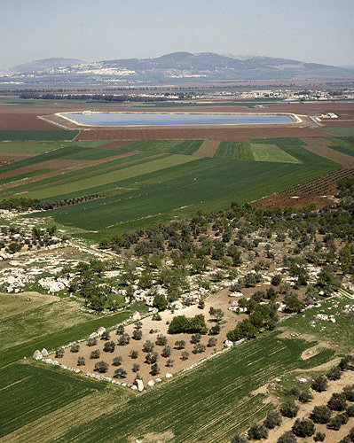 Israel, aerial view of cultivated fields in Jezreel Valley, reservoir in background