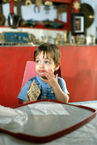 Israel little Jewish boy eating matzot at Passover