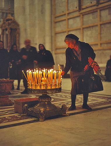 Israel, Jerusalem, Greek Cypriot woman placing a candle in the Holy Sepulchre Church