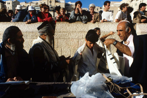 Israel Jerusalem Sephardic Jewish boy being helped to put on his Tallit  prayer shawl at his bar mitzvah