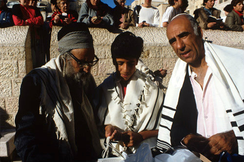 Israel Jerusalem Sephardic Bar mitzvah the Rabbi with the boy and his Father, the boy is holding the fringe of his tallit