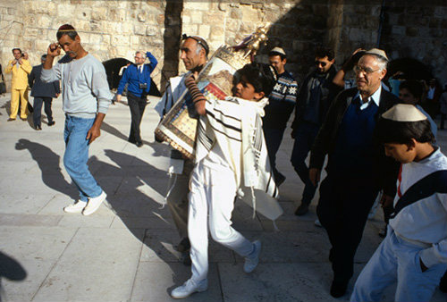 Israel Jerusalem Sephardic Jewish boy carrying the Torah scroll of the law at the Western Wall