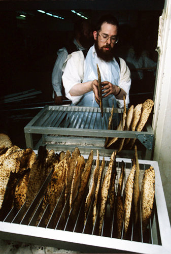 Israel Jerusalem Ultra -Orthodox Jews make Matza for Pesach  Passover Festival Jew removes bread from baking rack