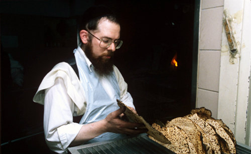 Israel Jerusalem Ultra-Orthodox Jews make Matza for Pesach  Passover Festival Jew removes Matza from the baking rack