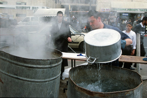 Israel Jerusalem Ultra-Orthodox Jews boil utensils to make them Kosher for Pesach  Passover Festival