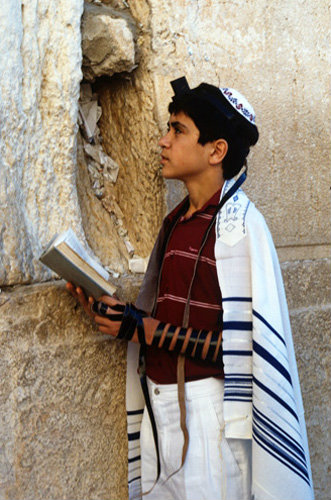 Israel Jerusalem Bar mitzvah boy at the Western Wall praying