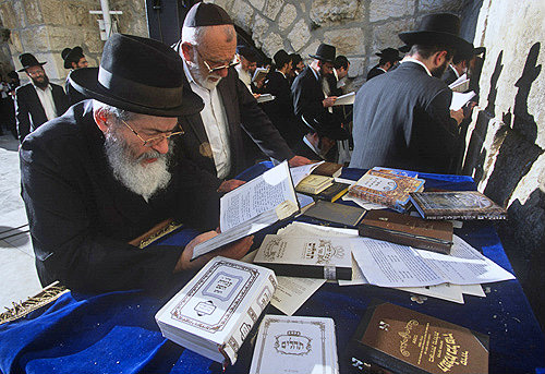 Israel,  Jerusalem, an elderly orthodox Jew reading from the Tanakh the Western Wall