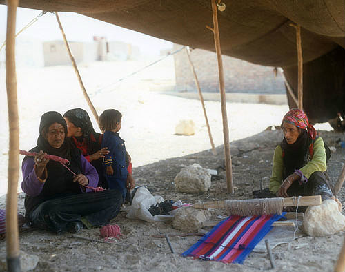 Bedouin woman weaving rug in her tent near Petra, Jordan