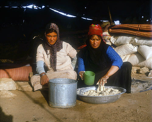 Bedouin woman making dough for bread in her tent near Madaba, Jordan