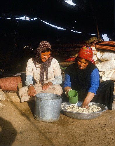 Bedouin woman making dough for bread in her tent near Madaba, Jordan