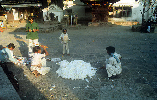 Children beating kapok, Nepal