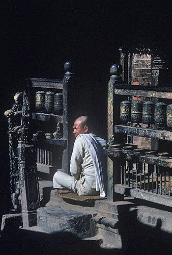 Nepalese Buddhist priest with prayer wheels
