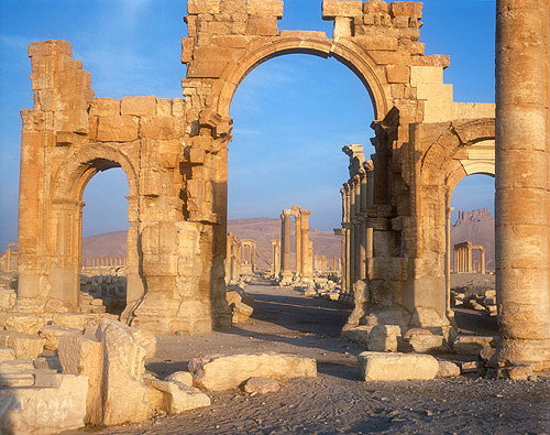 Triumphal arch and ruins at sunrise, Palmyra, Syria