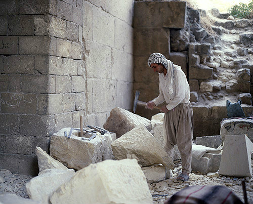 Syria, Aleppo, stone worker inside the citadel