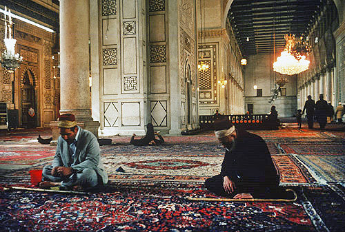 Omayyad Mosque which dates from eighth century, two muslims praying, Damascus, Syria