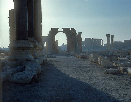 Colonnaded street and triumphal arch, second century, looking towards Temple of Bel, dedicated in 32 AD, sunrise, Palmyra, Syria