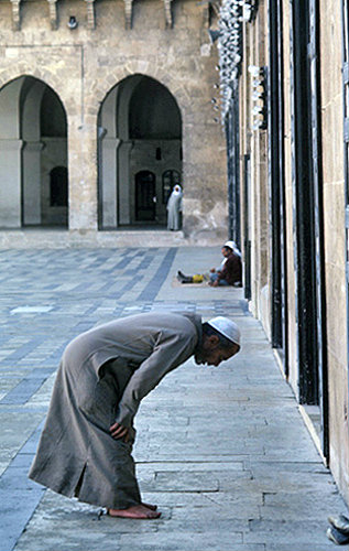 Syria, Aleppo, man praying in the courtyard of the Great Mosque