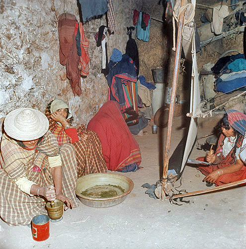 Berber women working at the loom and pounding henna, Island of Djerba, Tunisia