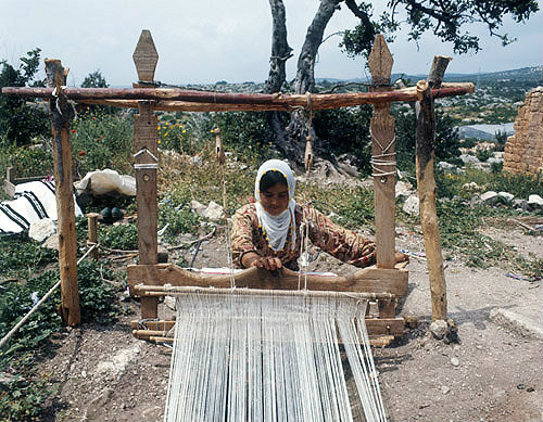 Nomad girl working at a loom near Eleusis, Cilicia, Turkey