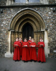 Choir boys singing outside the south choir door of St Albans Cathedral or St Albans Abbey, England