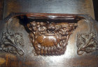 Misericord of sow suckling piglets in a wood, watched by a man, fourteenth century, Chester Cathedral, Cheshire