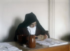 Sister Mary eating meal in refectory, Thicket Priory, Thorganby, North Yorkshire, England