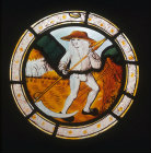 Labours of the months, man scything wheat, posssibly July, from Brandiston Hall Norfolk 16th century stained glass roundel by Norwich School ca 1500