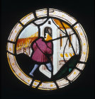 Labours of the months, taking shelter from a shower, April or November 16th century stained glass roundel from Brandiston Hall by Norwich School now in the Norwich Castle Museum and Art Gallery