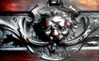 Green Man, carving on lntel of tallboy secretaire, by W.S.Williamson, circa 1903, private property