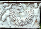 Putto carrying garland, and comic mask, marble Roman sarcophagus, circa 100, bought in Rome by Lord Astor, Cliveden House, Buckinghamshire, England