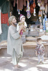 Afghanistan, Herat, man with child outside shop