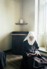 Sister Elizabeth Carmel reading in her cell, Thicket Priory, Thorganby, North Yorkshire, England