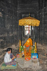 Buddhist statue and devotee inside main prasat, Bayon temple, Angkor Thorn, completed late twelfth century, Cambodia