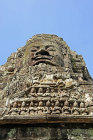Carved face and praying figure on gopura on east side, Bayon temple, Angkor Thom, late twelfth century, Cambodia