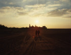 Egypt, Wadi el Natrun, Deir el Sourian monastery and two coptic monks at sunset