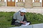 Student reading in courtyard of Masjed-e Jameh (Friday mosque) and madrasah (religious school), built 1826, Zanjan, Iran