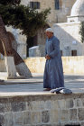 Israel, Jerusalem, Muslim man praying outside the Dome of the Rock