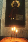 Israel, Greek Orthodox Monastery of St George, Wadi Qilt, founded in the fourth century, candles lit in church before image of Christ
