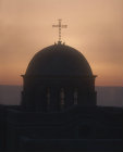 Doves and cross on dome of church at sunrise, Bethany, Israel