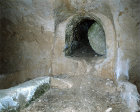 Israel, Bethphage, rock-cut tomb with rolling stone seen from the inside, there are six graves in pairs