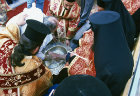 Israel, Jerusalem, Greek Orthodox priests washing feet on Maundy Thursday outside the Holy Sepulchre Church