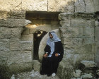 Arab outside rolling stone tomb, similar to that of Christ, south west of Hebron, Israel