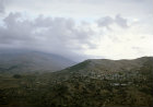 Israel, village in the foothills of Mount Hermon, seen under cloud in the background