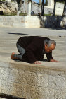 Israel, Jerusalem, Muslim man praying near the Dome of the Rock