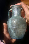 Shlomo Moussaieff holding first century AD glass amphora, signed by Ennion, about 8 inches high, dug up inside the city walls of Jerusalem, Israel