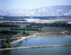 Israel, aerial view of the Jordan valley looking across fish ponds and orchards to Gilead mountains