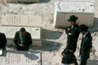 Israel Jerusalem strict Orthodox Jews around grave in cemetery on the Mount of Olives